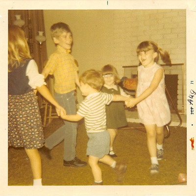 Five children playing ring-around-the-rosie.